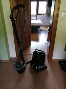 a vacuum cleaner sitting on the floor in a room at Chalet Anna Appartment in Uttendorf