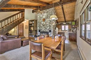 a dining room with a table and a stone wall at Rustic Cabin with Fireplace - 2 Mi to Grand Lake! in Grand Lake