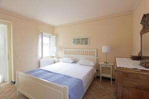 a bedroom with a bed and a desk and a window at Casa Marsilva - holiday apartment in old town centre, near the lake in Toscolano Maderno