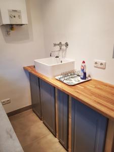 a bathroom with a sink and a counter with a sink at Ferienhaus mit großem Garten in Strandnähe in Scharbeutz +4 photos