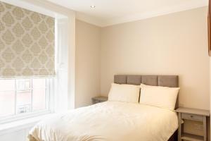 Ένα ή περισσότερα κρεβάτια σε δωμάτιο στο Molloys Apartments +133 φωτογραφίες