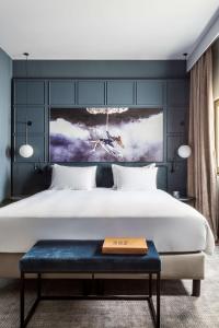 a bedroom with a large bed and a large window at Radisson Blu Hotel, Madrid Prado in Madrid