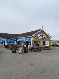 a building with picnic tables in front of it at Pack and go holidays in Ingoldmells