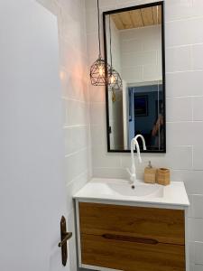 a bathroom with a sink and a mirror at Shantell Boutique Apartments in Netanya