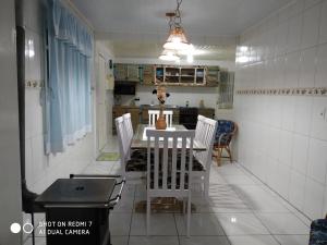 kuchnia ze stołem i krzesłami w pokoju w obiekcie Casa Karina w mieście Urubici