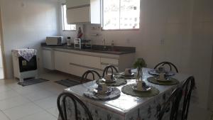 a kitchen with a table with four chairs and a kitchen with a counter at casa/apartamento centro Santa Teresa-ES in Santa Teresa