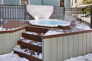 a hot tub with snow on top of a fence at Main Street Junction in Breckenridge