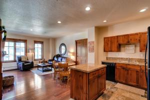 a kitchen and living room with a table and a dining room at Main Street Station II in Breckenridge