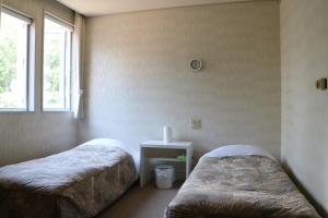 Postel nebo postele na pokoji v ubytování 白樺湖ペンションロック