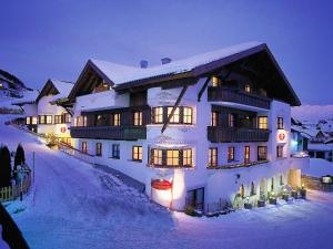 a large building in the snow at night at ... mein romantisches Hotel Toalstock in Fiss