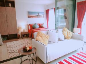 a living room with a white couch and a bed at Hua Hin La Casita Beautiful Two Bedroom Condo With Great Views in Hua Hin