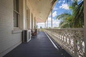 a balcony of a building with benches on it at Denison Boutique Hotel in Rockhampton
