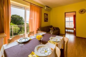 a dining room with a table and a large window at Two-Bedroom Apartment in Crikvenica XII in Dramalj