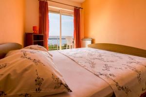 a bedroom with a bed with a view of the ocean at Two-Bedroom Apartment in Crikvenica XII in Dramalj