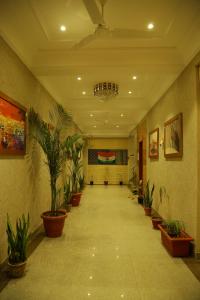 a hallway with potted plants in a building at The Jawai Gateway in Sheoganj