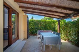 a table and chairs on a patio with awning at Appartamento del Cormorano in Olbia