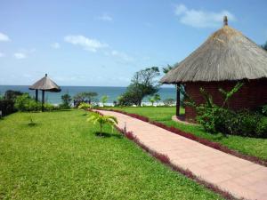a path leading to a hut with the ocean in the background at Leo's Beach Hotel - Adults Only in Brufut