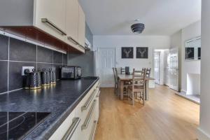 a kitchen with a table and a dining room at Refurbished Plush Property Great Transport Links in Sheffield