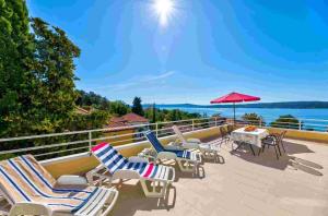 a patio with chairs and a table with a view of the water at Apartment in Crikvenica 14104 in Sopaljska