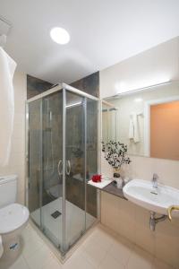 a bathroom with a shower and a toilet and a sink at Hotel Miño in Ourense