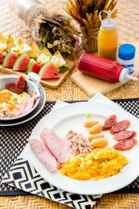 a plate of breakfast food on a table with fruit at Vimarn Samed Resort in Ko Samed