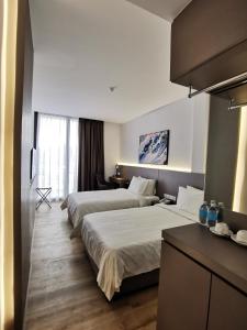 Postel nebo postele na pokoji v ubytování Otel Hotel Sibu
