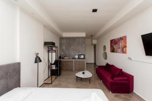 a living room with a red couch and a table at Skyroof SKG in Thessaloniki