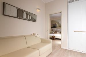 a living room with a white couch and a bedroom at Hotel Life in Rimini