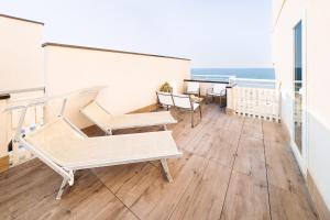 a balcony with benches and a view of the ocean at Hotel Life in Rimini
