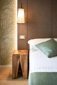 a bedroom with a bed and a table and a lamp at Hotel Life in Rimini