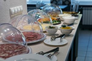 a buffet line with different types of food in domes at Hotel Mashuk in Pyatigorsk