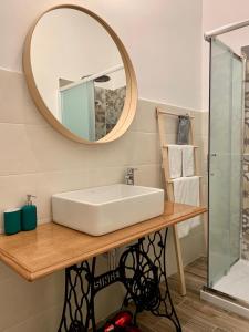 a bathroom with a white sink and a mirror at AllYouCanTrip - La Nova in Naples +47 photos