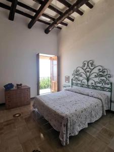 a bedroom with a large bed and a large window at Casa Garibaldi in Leni