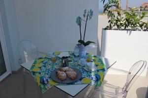 a table with a plate of pastries on it at Terrazze Naos in San Leone