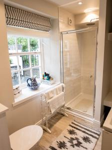 a bathroom with a shower and a window at Rockport Lodge in Cushendun