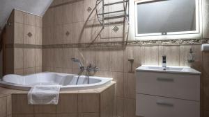 a bathroom with a tub and a sink at Karpacz Deptak, Sun & Snow in Karpacz