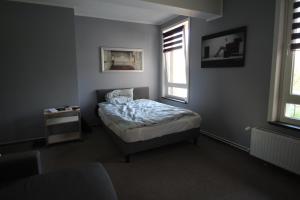 a small bedroom with a bed and a window at Fackenburgerapartments in Lübeck