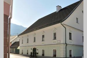 a large white building with a black roof at Klein und Fein in Spital am Pyhrn