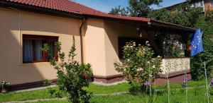 a small house with a garden in front of it at La Mihai in Lupeni