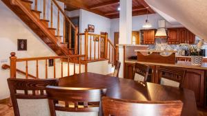 a kitchen with a table and chairs and a staircase at Karpacz Deptak, Sun & Snow in Karpacz