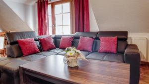 a living room with a couch with pink and purple pillows at Apartamenty Sun & Snow Karpacz Deptak in Karpacz