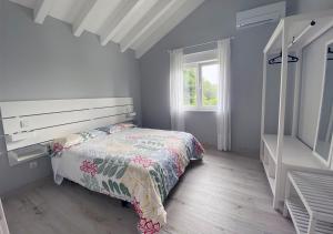 a bedroom with a bed and a window at Villa Rosa in Santillana del Mar