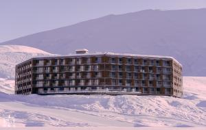 a building in the middle of a snow covered mountain at Gudauri, Atrium Suites in Gudauri