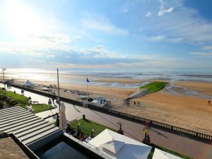 a view of a beach and the ocean from a building at Apartment Le Caneton-3 by Interhome in Cabourg