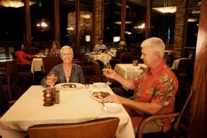 a man and a woman sitting at a table in a restaurant at The Hotel at Black Oak Casino Resort in Tuolumne
