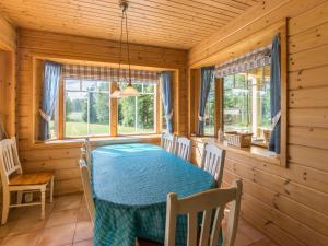 a dining room with a table in a log cabin at Holiday Home Pihlajaniemi by Interhome in Sastamala