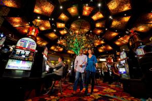 a group of people standing in a casino at The Hotel at Black Oak Casino Resort in Tuolumne