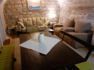 a living room with a table with a vase on it at Apartments Sekoko in Šibenik