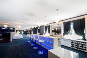 a hair salon with blue and white counters and chairs at Hotel Sękowski in Legnica