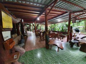a pavilion with tables and chairs in a restaurant at Putan-namsai Resort in Pak Chong